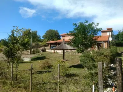 a garden with a house in the background at Suricabanias in Villa Yacanto
