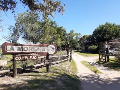 a sign for la morgan comedia on a road at Complejo La Morena in Mina Clavero