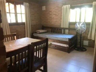 a room with two bunk beds and a fan at Complejo La Morena in Mina Clavero