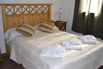 a bed with towels on top of it at Aguas Mornas Cabañas in Mina Clavero