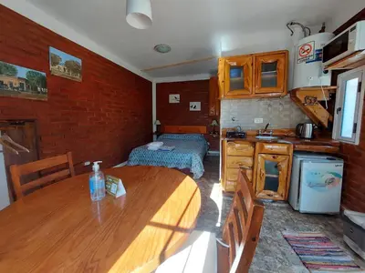 a kitchen with a wooden table in a room at Cerros Azules in Trapiche