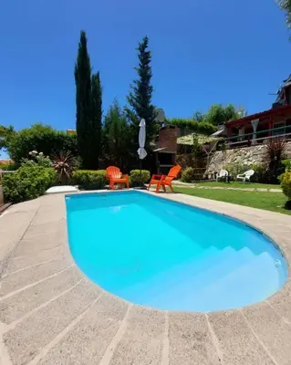 a large blue swimming pool in a yard at Cerros Azules in Trapiche