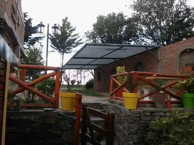 a black umbrella on top of a brick building at Cerros Azules in Trapiche