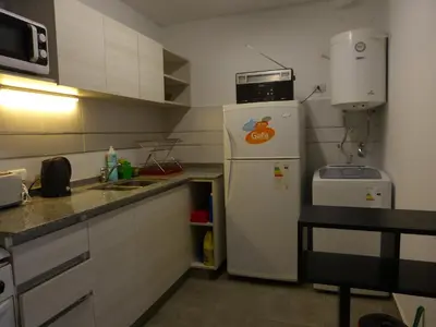 a small kitchen with a refrigerator and a microwave at Ignea in Cordoba