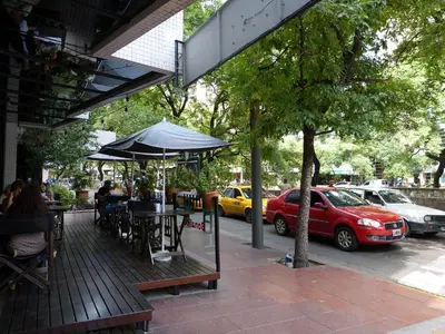a wooden deck with a table and an umbrella at Ignea in Cordoba