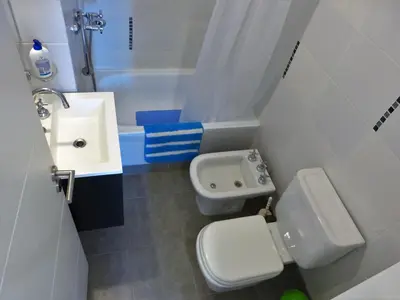a small bathroom with a toilet and a sink at Ignea in Cordoba