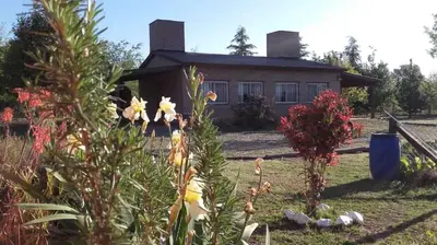 a house with a garden in front of it at Cabañas Hilario in Los Reartes