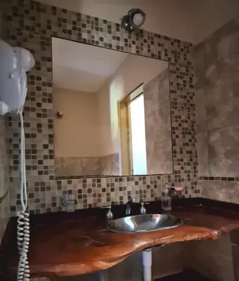 a bathroom with a sink and a mirror at siete colores in Santa Rosa de Calamuchita