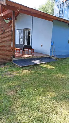 a bench sitting on a porch of a house at siete colores in Santa Rosa de Calamuchita