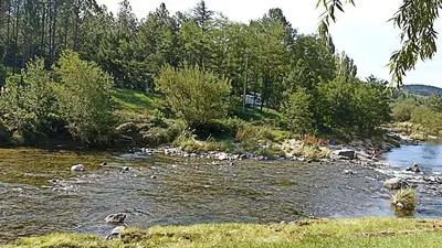 a river with a bunch of rocks in the water at siete colores in Santa Rosa de Calamuchita