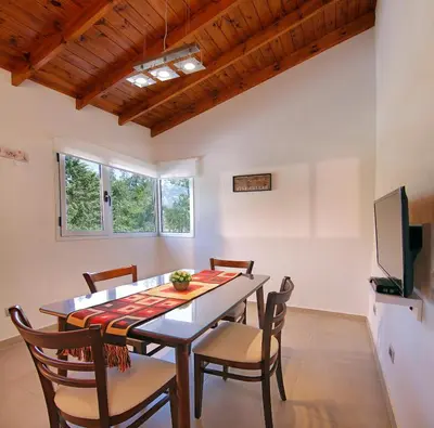 a dining room with a table and chairs at Altos del Rio (Solo parejas) in Los Reartes