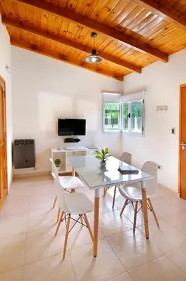 a dining room with a table and chairs at Altos del Rio (Solo parejas) in Los Reartes