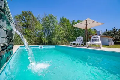 a swimming pool with a water fountain at Altos del Rio (Solo parejas) in Los Reartes