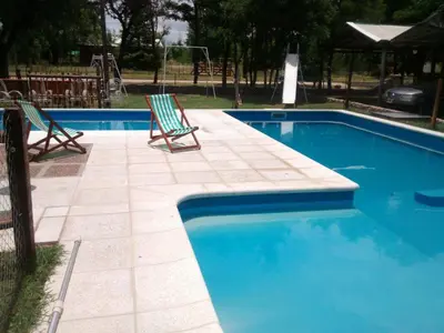two chairs sitting next to a swimming pool at Posada del Tata in Nono