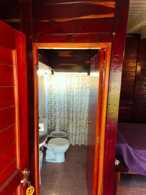 a bathroom with a toilet and a sink at Posada del Tata in Nono