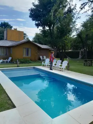 a young boy standing next to a swimming pool at Alpamayo in Nono
