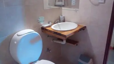 a bathroom with a white sink and a toilet at Alpamayo in Nono