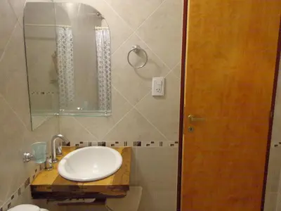 a bathroom with a white sink and a mirror at Alpamayo in Nono