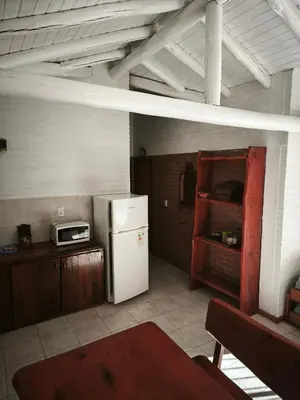 a kitchen with a white refrigerator and a microwave at Alpamayo in Nono