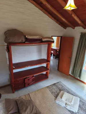 a room with a table with luggage on top of it at Alpamayo in Nono