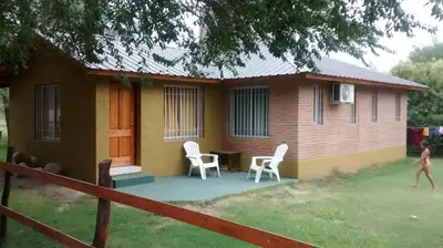 a small house with a table and chairs in front of it at Alpamayo in Nono