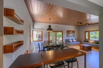 a dining room and living room with a wooden ceiling at Casas Acrux in Nono