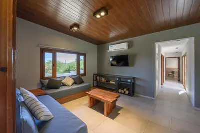 a living room with a blue couch and a fireplace at Casas Acrux in Nono