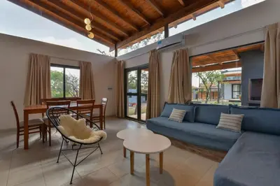 a living room with a blue couch and a table at Casas Acrux in Nono