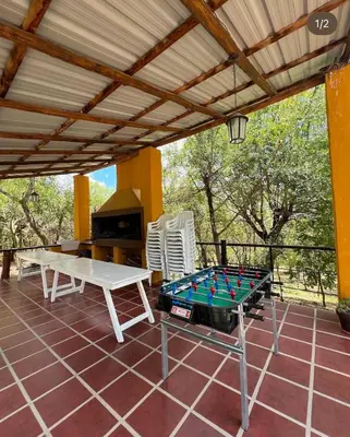 a patio with a pool table and a grill at Posada Altos Del Consuelo in Nono