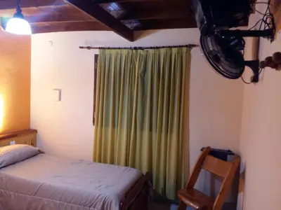 a bedroom with a bed and a green curtain at 