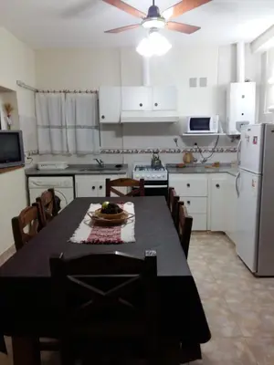 a kitchen with a table and chairs and a refrigerator at 