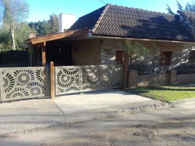 a fence in front of a house with a gate at 