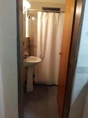 a bathroom with a white shower curtain and a sink at 