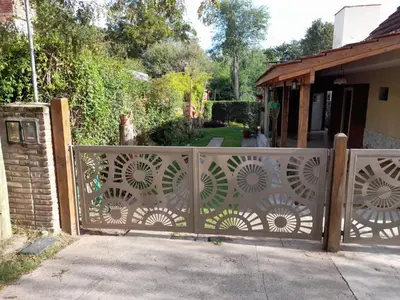 a gate to a house with a garden at 