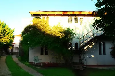 a house with a spiral staircase in the yard at Villa Leandro in Mina Clavero