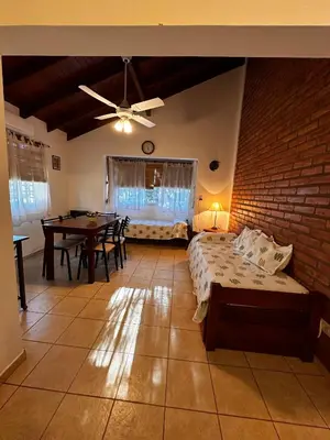 a bedroom with a bed and a dining room table at Luna Azul in Merlo