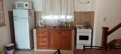 a small kitchen with a white refrigerator and a stove at Luna Azul in Merlo