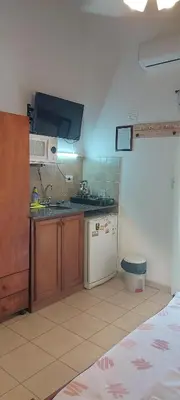 a small kitchen with a sink and a stove at Luna Azul in Merlo
