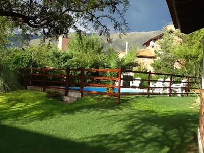 a wooden fence in a yard with green grass at Luna Azul in Merlo
