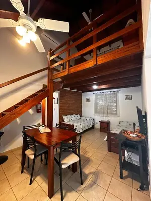 a room with a table and chairs and bunk beds at Luna Azul in Merlo