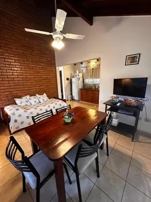 a room with a dining table and a bed at Luna Azul in Merlo