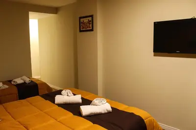 a hotel room with two beds with towels at Savannah Cordoba Hotel in Cordoba
