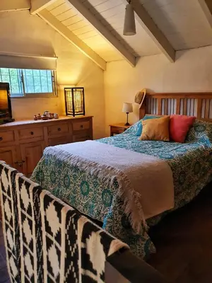 a bedroom with a large bed and a window at Cabaña Josefina in Los Reartes