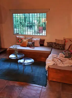 a living room with a couch and a window at Cabaña Josefina in Los Reartes