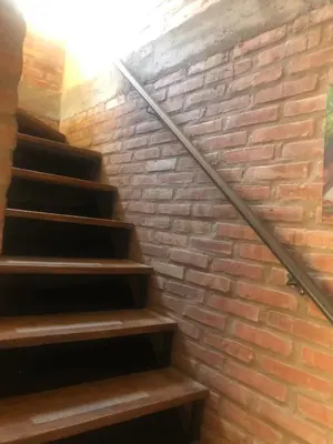 a brick wall and stairs in a building at Cabañas Don Eduardo in Mina Clavero
