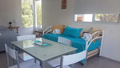a living room with a couch and a table at Cabañas Don Eduardo in Mina Clavero