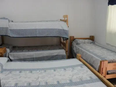 a room with three bunk beds in it at La Nona in Villa Cura Brochero