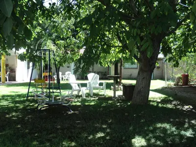 a group of chairs sitting under a tree at La Nona in Villa Cura Brochero