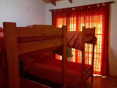 a bunk bed in a room with a window at Cabañas Villa del Mirador in Bialet Massé