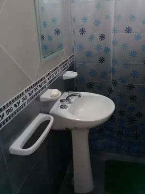 a bathroom with a white sink and a mirror at Cabañas Villa del Mirador in Bialet Massé